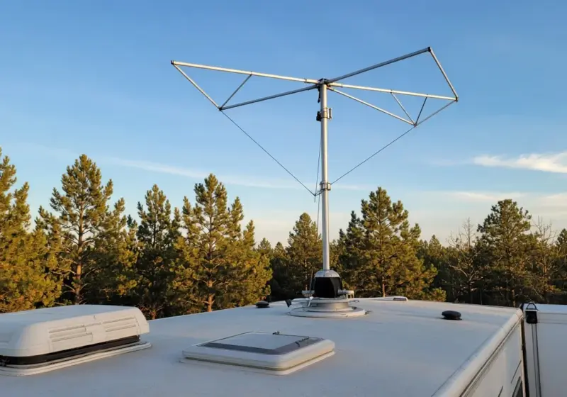 An RV TV antenna on the roof against a blue sky